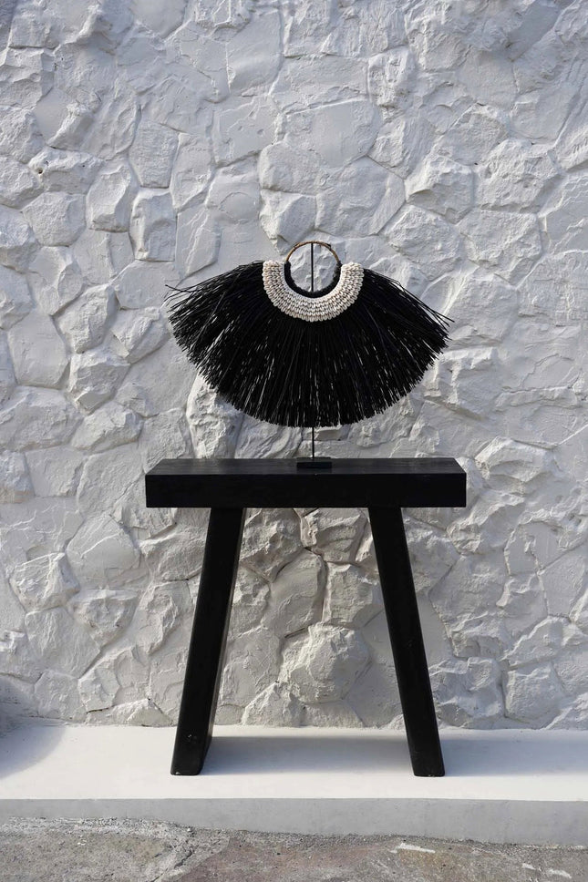 De Alang-cowrie op een standaard