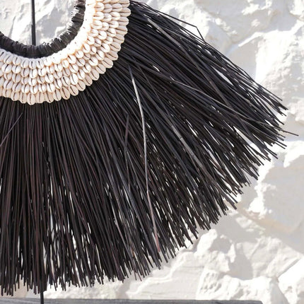 De Alang-cowrie op een standaard